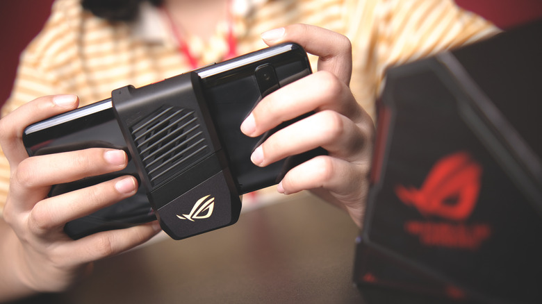 young woman holding a modern gaming phone