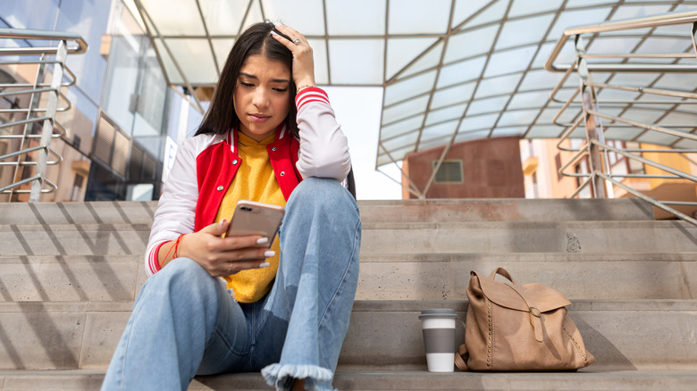 frustrated girl using a smartphone