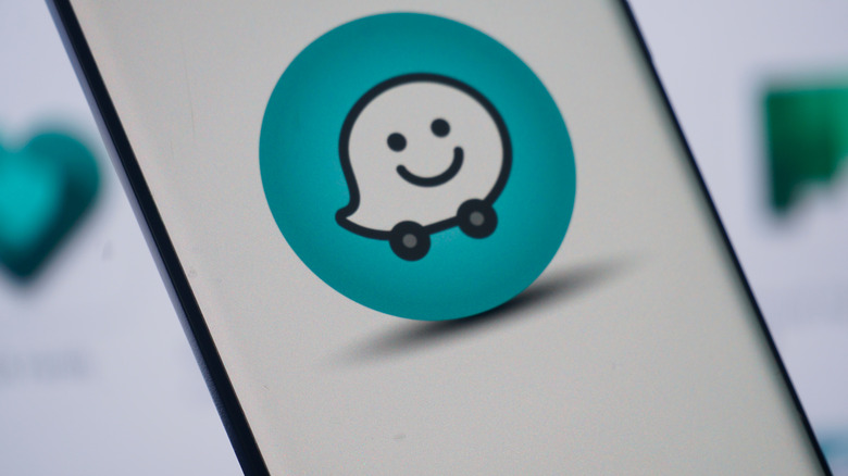waze logo on a smartphone screen placed against a light background