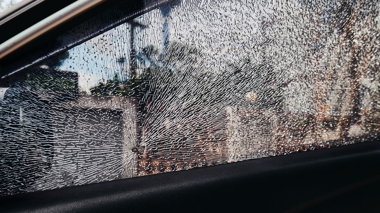 Close-up view of a car window shattered entirely
