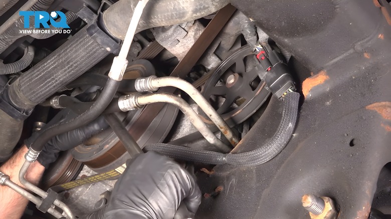 Mechanic showing the 2015 Chevy Silverado's brake vacuum pump