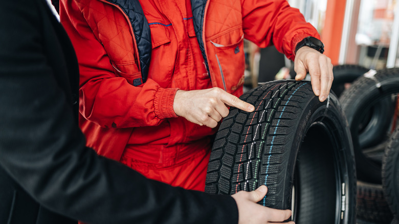 man pointing to tire