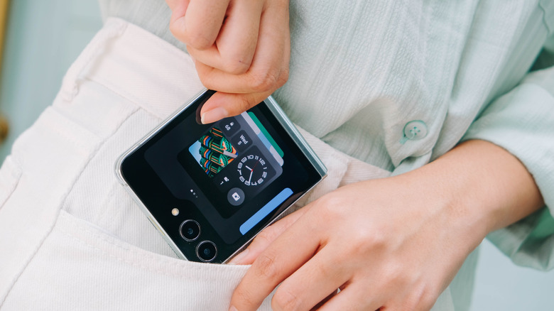 Person putting a Samsung Galaxy Z Flip7 phone inside his pocket