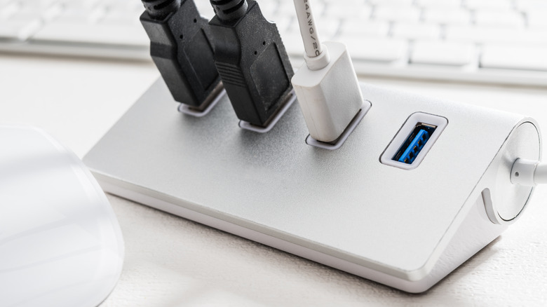 silver USB dock with three USB cables plugged in