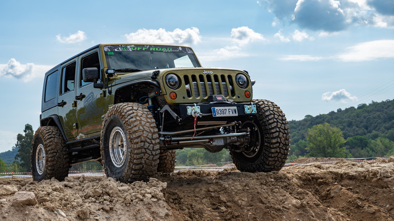 A Jeep Wrangler modified for off-road with large tires.