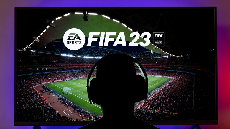 person playing FIFA23 on TV