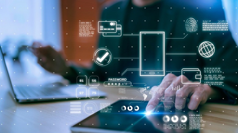man pointing on tablet with icons superimposed over it