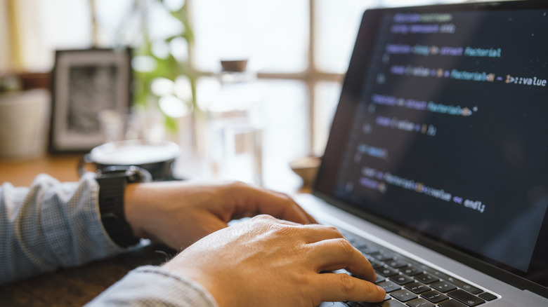 person coding on MacBook
