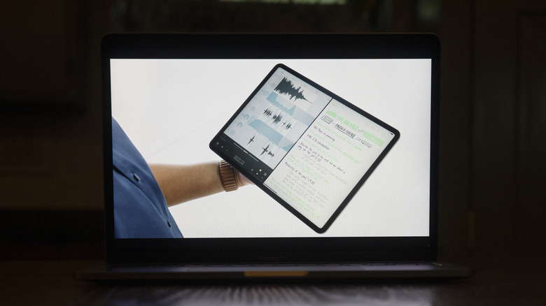 man holding iPad with split screen function