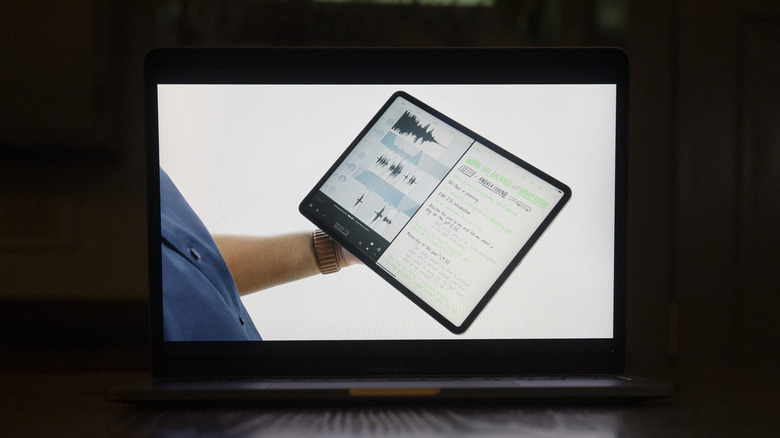 man holding iPad with split screen function