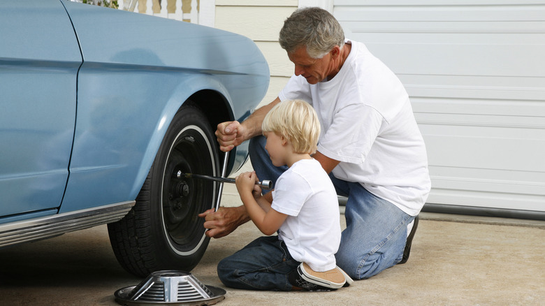 father and son changing tire
