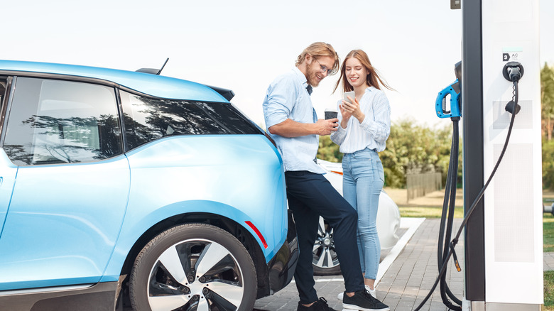 couple charging EV