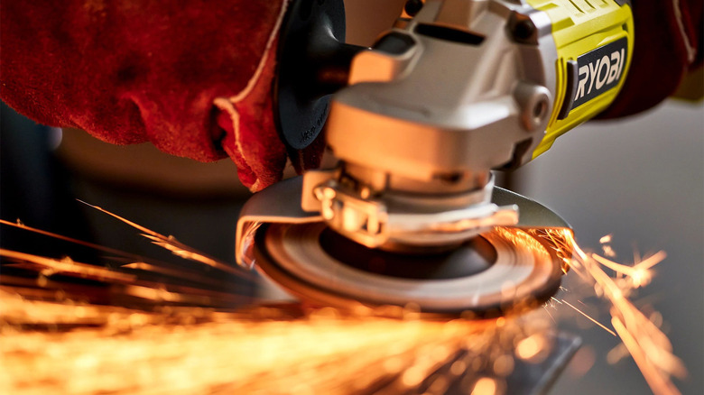 person using ryobi angle grinder