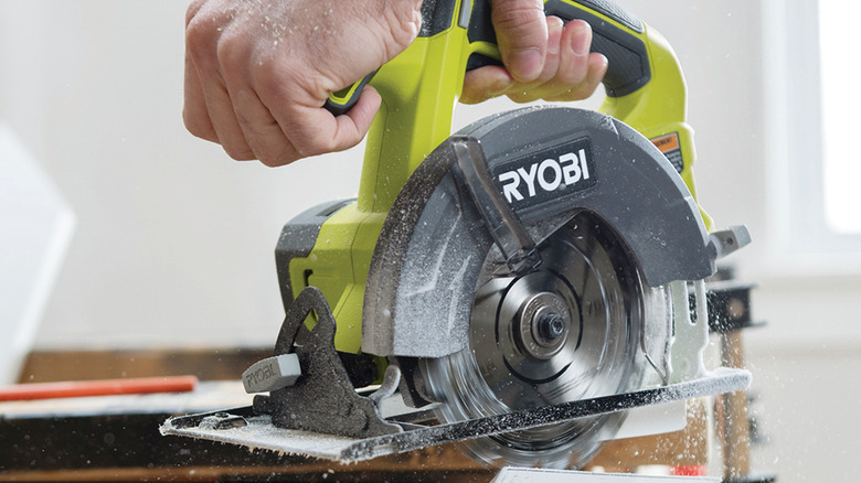 person using ryobi circular saw