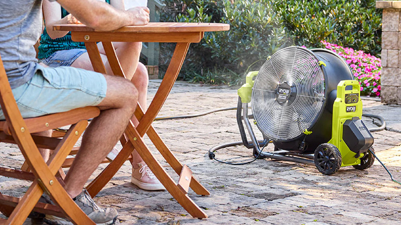A Ryobi misting air cannon running on a patio.