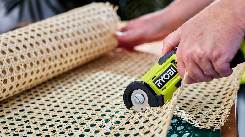 man cutting furniture with cutter
