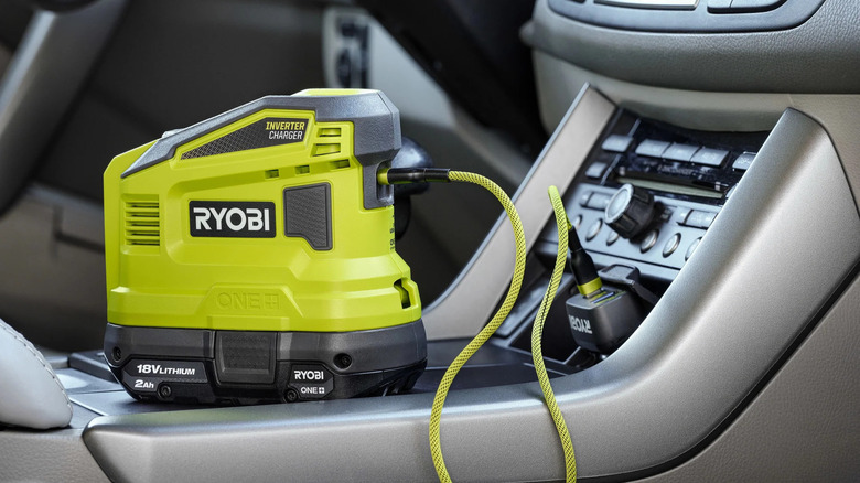 The Ryobi 150 Watt Power Source being charged by a car's 12V port
