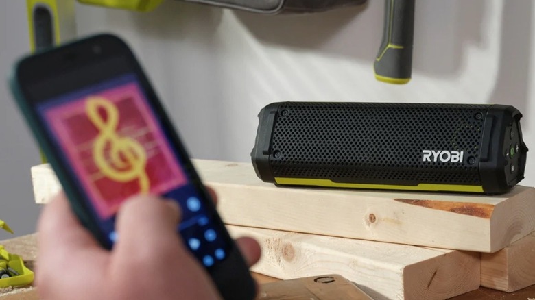 Person playing music through Ryobi speaker