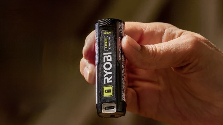 Person holding Ryobi USB battery
