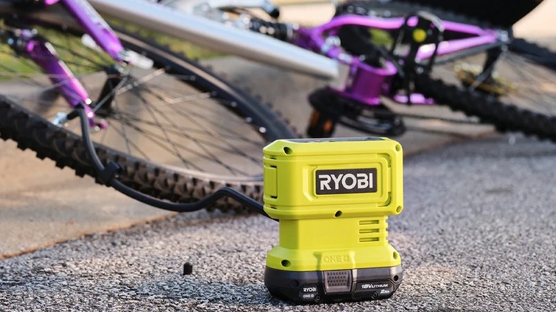 Ryobi inflator pumping air into a bike tire