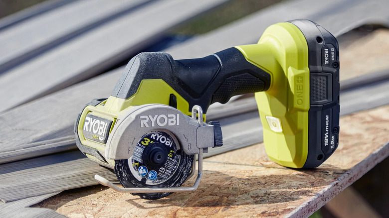 Ryobi PSBCS02B compact cut-off tool on an outdoor workbench
