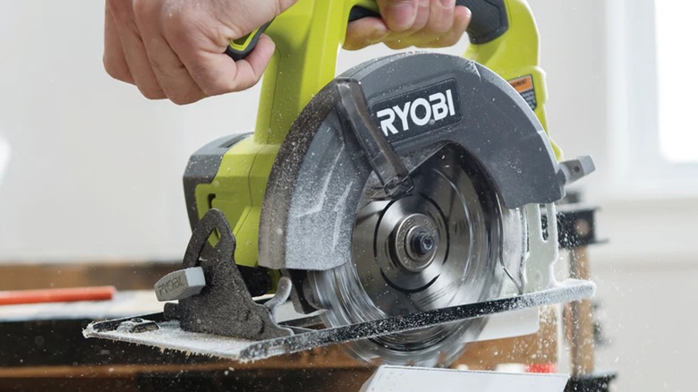 A person using a Ryobi circular saw.