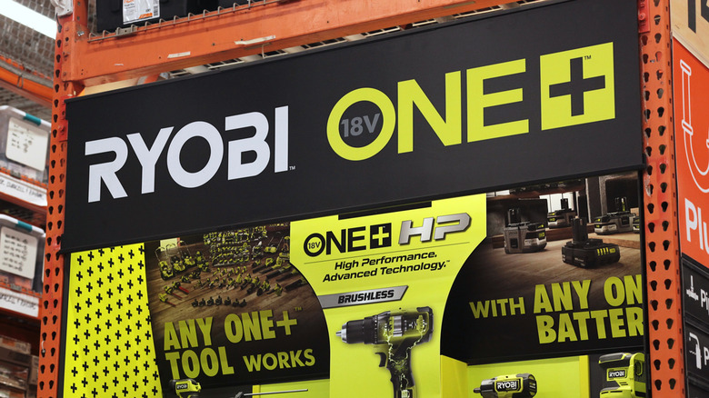 A sign inside Home Depot showing Ryobi ONE+ 18V tools