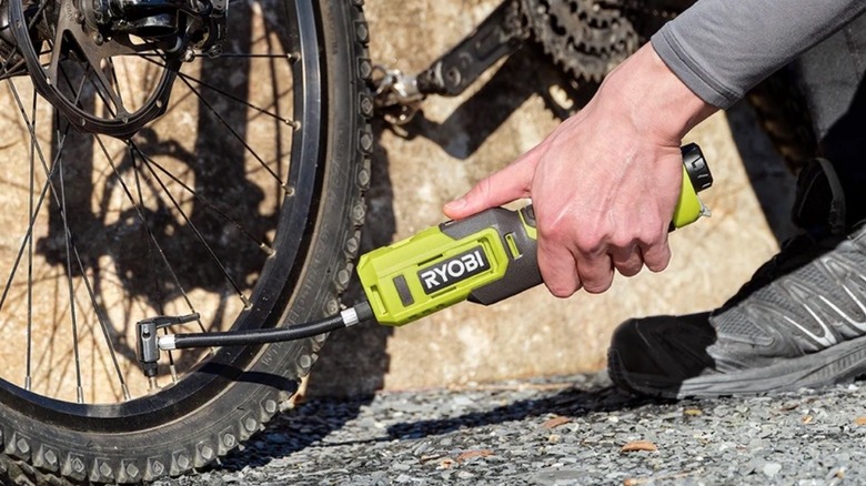 Person using Ryobi Lithium Inflator