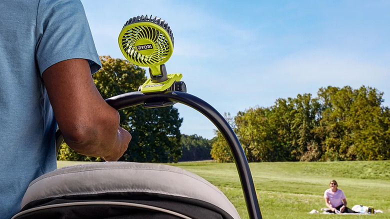 A man with Ryobi clamp fan on stroller