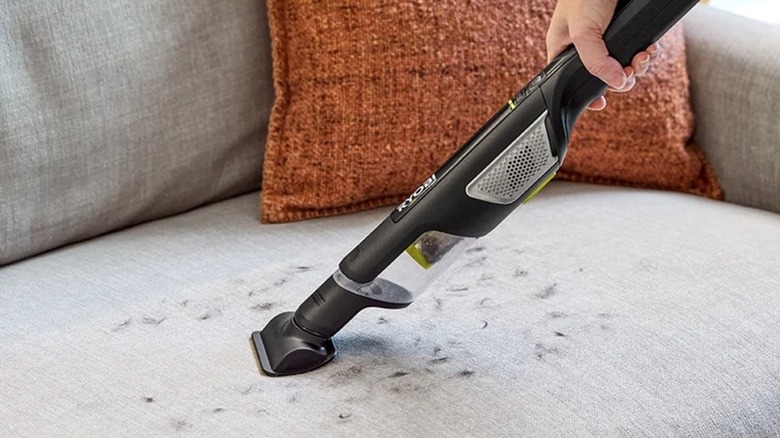 Person using Ryobi USB Lithium hand vacuum
