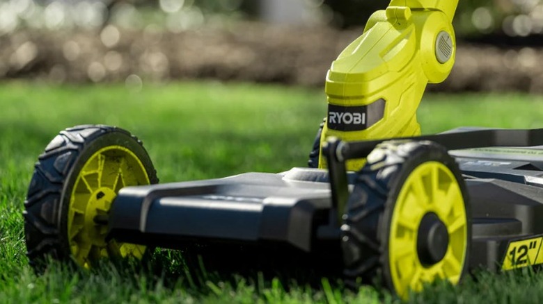 Close up of ONE+ 18-Volt 12-inch Cordless 3-in-1 Trim Mower cutting grass