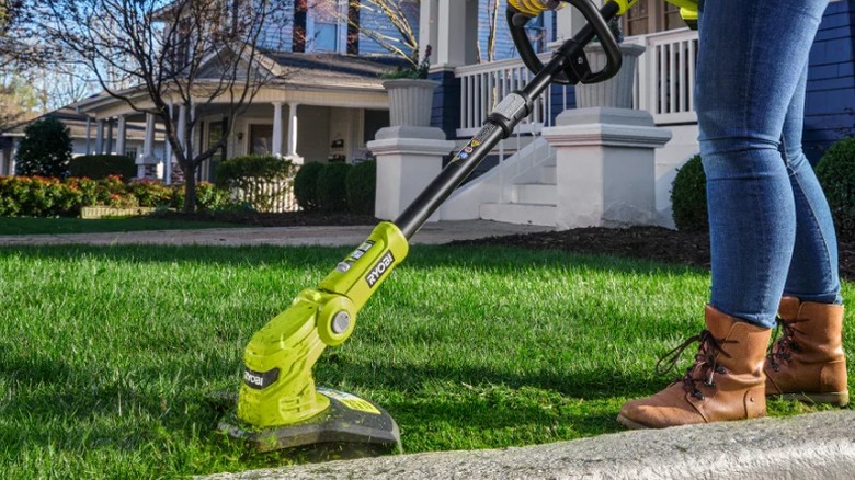 Person edging lawn with ONE+ 18-Volt 12-inch Cordless 3-in-1 Trim Mower