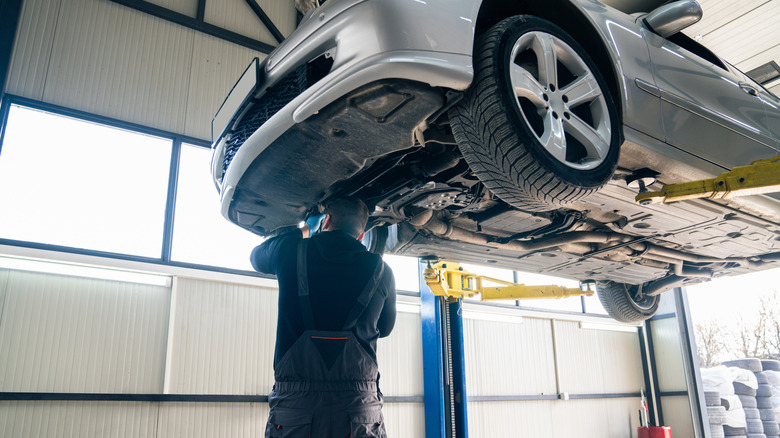 a car being serviced by a mechanic