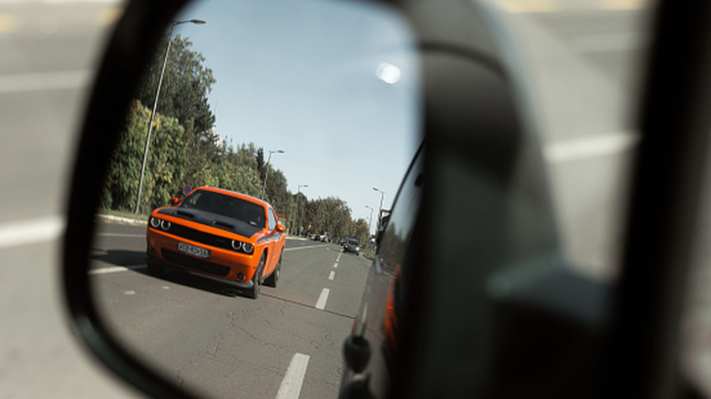 car in right side mirror about to overtake driver in left lane