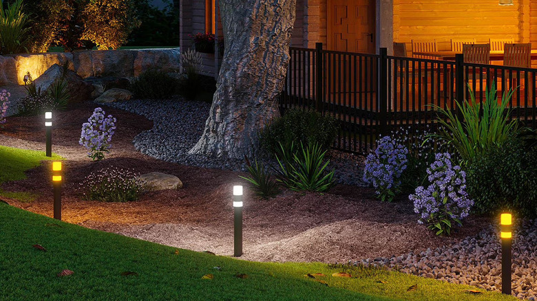 A row of outdoor lights next to a deck.