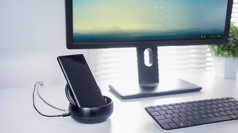 Samsung phone in DeX mode connected to a monitor and keyboard