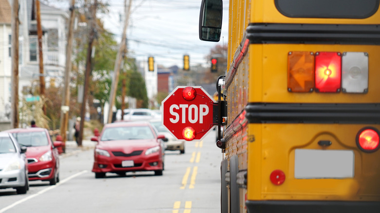A school bus with its stop sign extended.