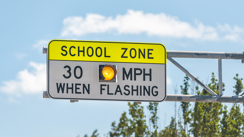 A school zone speed limit warning sign.