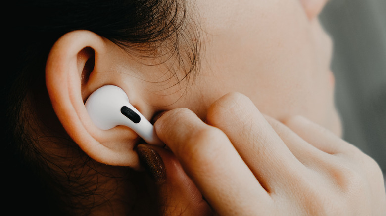 Person using AirPods Pro touch controls