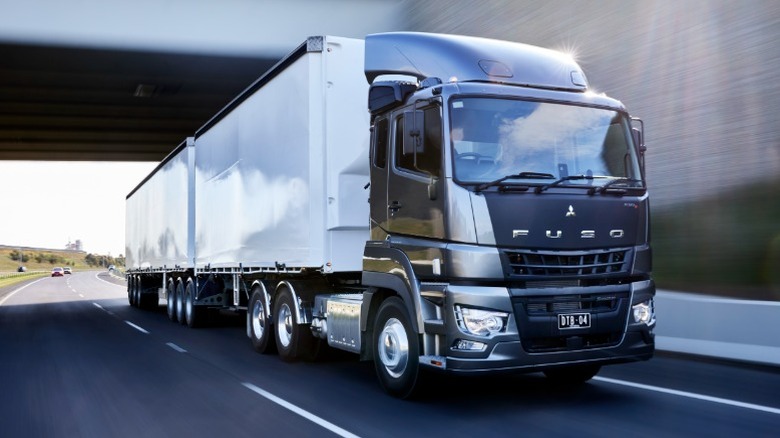 A gray Fuso Shogun semi-truck driving on a highway