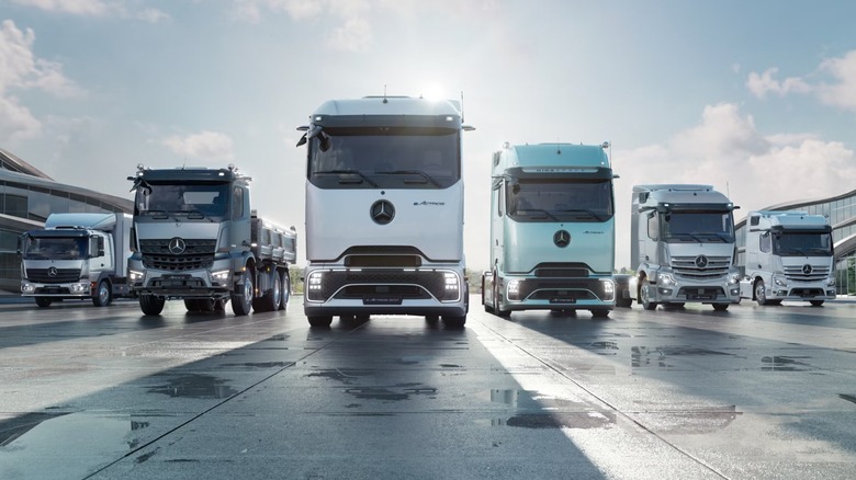 Mutliple Mercedes-Benz trucks parked onenext to the other.