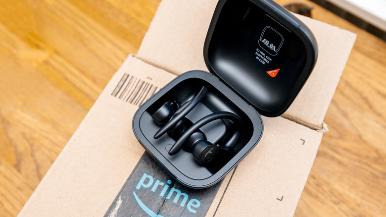 A pair of Beats By Dre earbuds sitting on top of an Amazon package