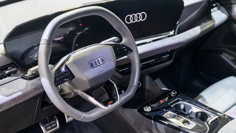 A close-up of a black piano plastic Audi Q6 interior.