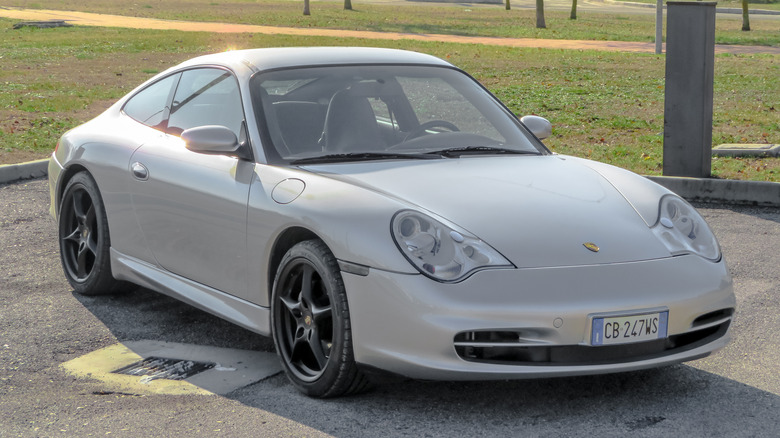 A silver 996 Porsche Carrera parked.