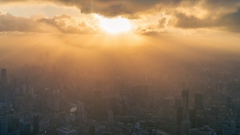 image showing sun peaking out from clouds