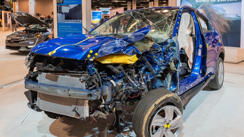 A wrecked vehicle that has been crash tested by the IIHS on display inside