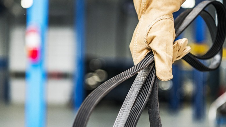 gloved hand with serpentine belt