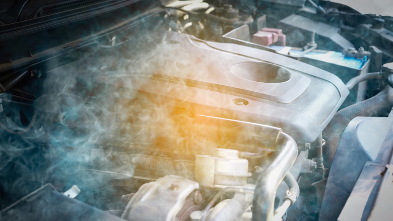 Smoke coming from an overheated car engine