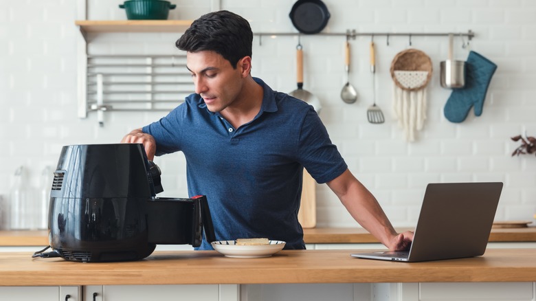 man using air fryer