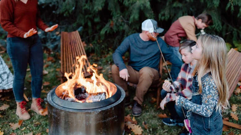 Family around fire making smores